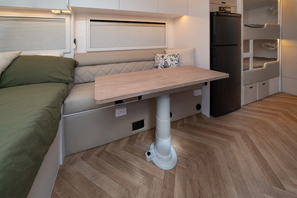 Kokoda F196 XC2 interior showing a dinette and two bunk beds