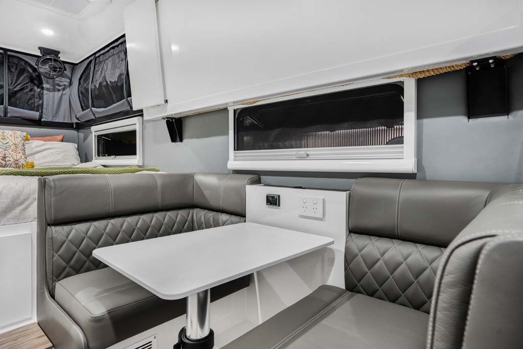 Dinette and raised pop-top canvas inside a Zone RV Expedition caravan